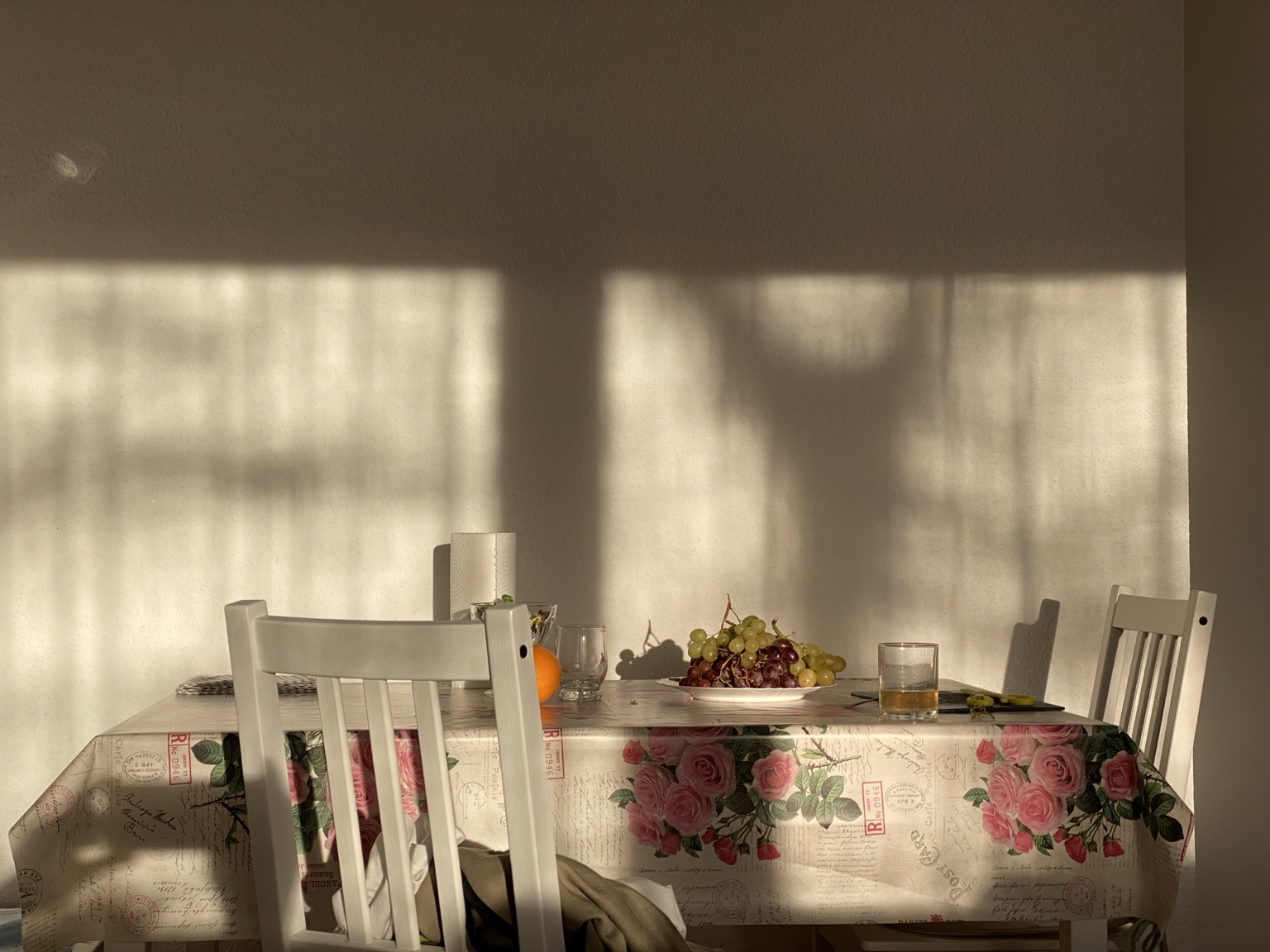 Table with grapes and strong window shadows